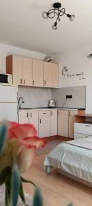 a kitchen with white cabinets and a bed in a room at Sea Breeze Studio at Fort Noks Resort in Sunny Beach