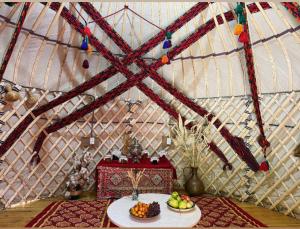 a room with a table with fruit in a yurt at Yurta in Nukus