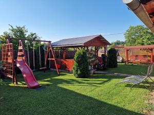 a playground in a yard with a slide at Casa Rodica Turda in Turda