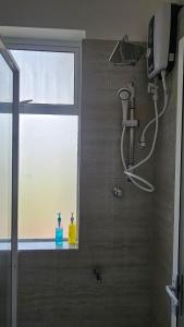 a bathroom with a shower with a window and a shower at RoaBaa Guesthouse in Batticaloa +59 photos