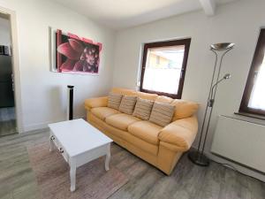 a living room with a couch and a table at FeWo Antweiler Unterdorf in Mechernich