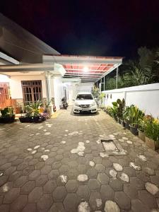 a white car parked in a garage at night at Homestay Anugerah Tumpak sewu in Lumajang