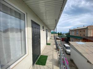 a balcony with a door and a window on a building at Гостевой дом Амир с Корумду in Korumdy
