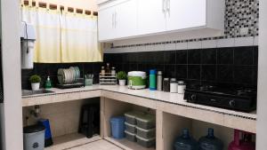 a kitchen with a sink and a counter top at Ambarosed Homestay in Ngaglik +6 photos
