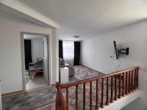 a living room with a couch and a mirror at Terme Guesthouse in Naryn
