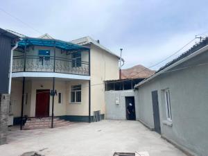 a building with a balcony on top of it at Terme Guesthouse in Naryn +20 photos