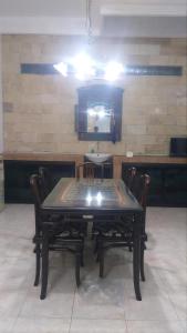 a dining room with a table with chairs and a mirror at Ambarosed Homestay in Ngaglik