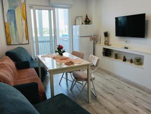 a living room with a table and a refrigerator at Apartament Pelicanul in Tulcea