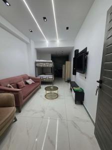 a living room with a couch and a tv at Luxury Studio in 6october in 6th Of October