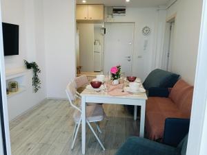 a small living room with a table and a couch at Apartament Pelicanul in Tulcea +51 photos