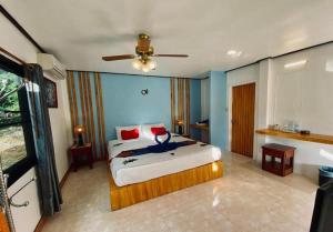 a bedroom with a bed and a ceiling fan at Villa Beside Swiming Pool With Garden View in Ban Map Khangkhao