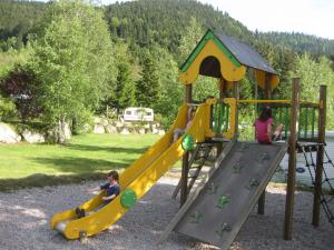 a group of children playing on a playground at Camping du Ô des bluches in La Bresse