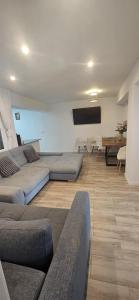 a living room with couches and a flat screen tv at Benning Haus Gandia in Gandía