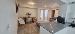 a kitchen and a living room with a couch and a table at Benning Haus Gandia in Gandía
