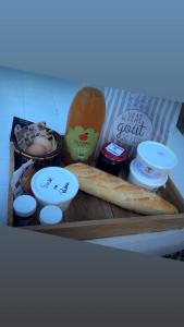 a tray of food with a loaf of bread and other ingredients at Maison Grebert in Gouffern en Auge