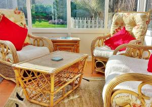 a living room with wicker chairs and a coffee table at The Perfect Beach Getaway for Couples in Sutton on Sea +44 photos