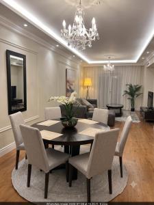 a dining room with a table and chairs and a couch at Cape Royale Luxury Suite 602 in Cape Town