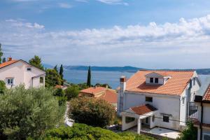 a view of a town with houses and the ocean at Korina Suites - 2 appartments, 1 with jacuzzy in Dramalj