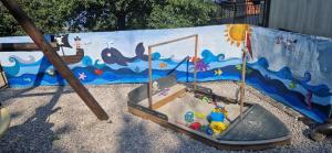 a playground with a play equipment in front of a play establishment at Adriana F. in Dobreć