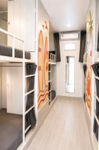 a room with bunk beds and surfboards on the wall at Shiralea Resort in Haad Yao