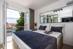 a bedroom with a large bed with a large mirror at Korina Suites - 2 appartments, 1 with jacuzzy in Dramalj
