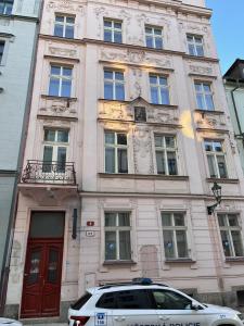 a building with a car parked in front of it at Perlová Suites in Pilsen