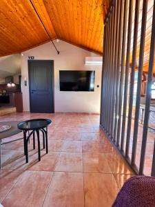 a room with a table and a tv on a wall at Tproject in Preveza
