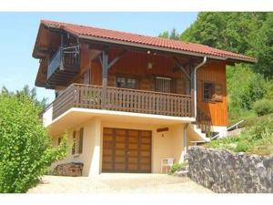 a large house with a balcony and a garage at Comfortable Chalet with spectacular mountain views in Verchaix