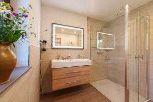 a bathroom with a sink and a shower at Reetdachhaus Laurin in Dranske in Dranske +37 photos