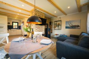 a living room with a table and a couch at Reetdachhaus Laurin in Dranske in Dranske