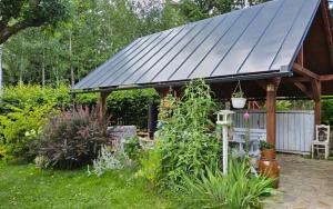 a gazebo with a solar roof in a garden at Chalupa pod Lysou - Apartma 4rooms in Rokytnice nad Jizerou