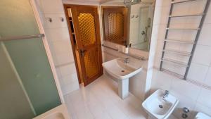 a bathroom with a sink and a toilet and a mirror at Appartamento Casa Viola in Monclassico +4 photos