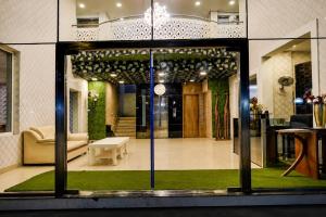 a store front with a glass door with a living room at Luxe By Lotels in Chennai