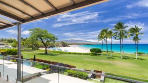 a view of the beach from the balcony of a resort at ❤PiH❤ Hapuna Surfside Beachfront Steps From Ocean B26 in Hapuna Beach