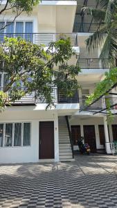 a building with stairs and a building with a courtyard at RoaBaa Guesthouse in Batticaloa