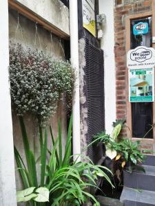 a group of plants in front of a building at Losmen Fadel Malioboro Jogja in Yogyakarta