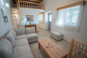 a living room with a couch and a table at Zia Village Miro in Lagoúdi Zía