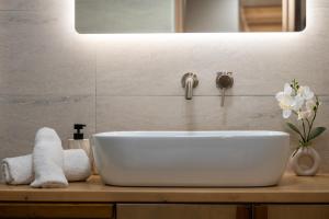 a white sink in a bathroom with a mirror at Zia Village Miro in Lagoúdi Zía +34 photos