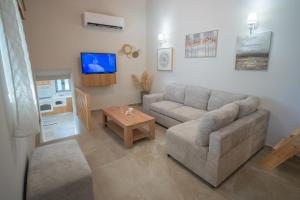a living room with a couch and a table at Zia Village Miro in Lagoúdi Zía