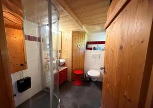 a bathroom with a toilet and a glass shower at Chalet 1813 Nature & Panorama in Montreux