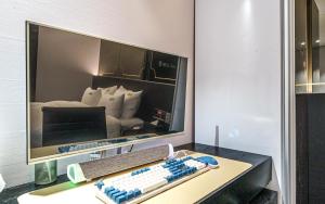 a desk with a computer monitor and a keyboard at 호텔 어게인 in Cheongju +61 photos