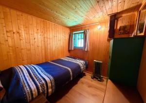 a bedroom with a bed in a wooden room at Chalet 1813 Nature & Panorama in Montreux