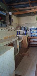 a kitchen with a cat laying on the floor at Nchaman Nest in Loiyangalani 