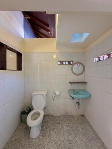a bathroom with a toilet and a sink at Kajeng Bungalow in Ubud +93 photos