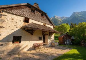 a house with a table and chairs in the yard at Chalet 1813 Nature & Panorama in Montreux