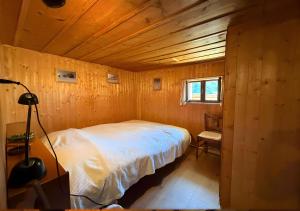 a bedroom with a bed in a wooden room at Chalet 1813 Nature & Panorama in Montreux