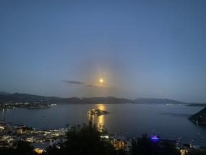 a view of a large body of water at night at Daphne Bungalows in Tolo