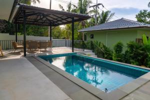 a swimming pool with a pergola next to a house at Luxury Villa with Private Pool, Srithanu in Ko Kong Nui