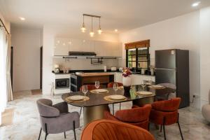 a kitchen with a table and chairs and a refrigerator at Luxury Villa with Private Pool, Srithanu in Ko Kong Nui
