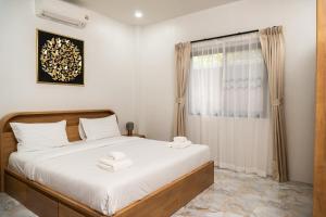 a bedroom with a bed with two towels on it at Luxury Villa with Private Pool, Srithanu in Ko Kong Nui